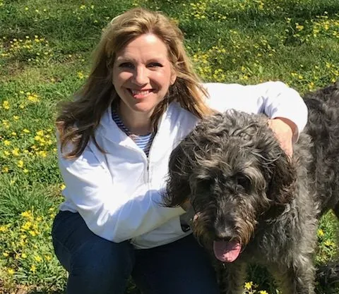 Laura Thomae Young outdoors with her dog Val